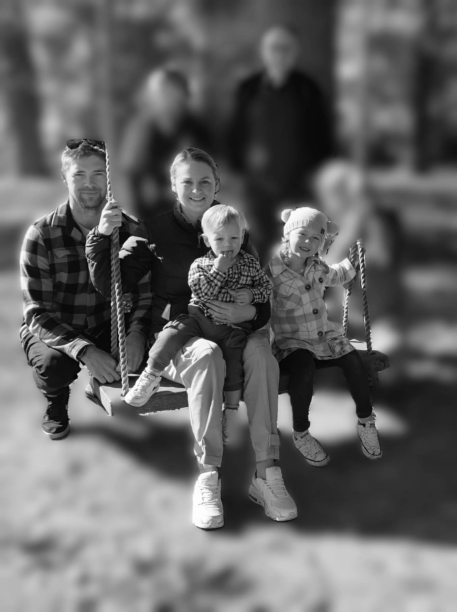 Ben Gardiner with his family on a garden swing