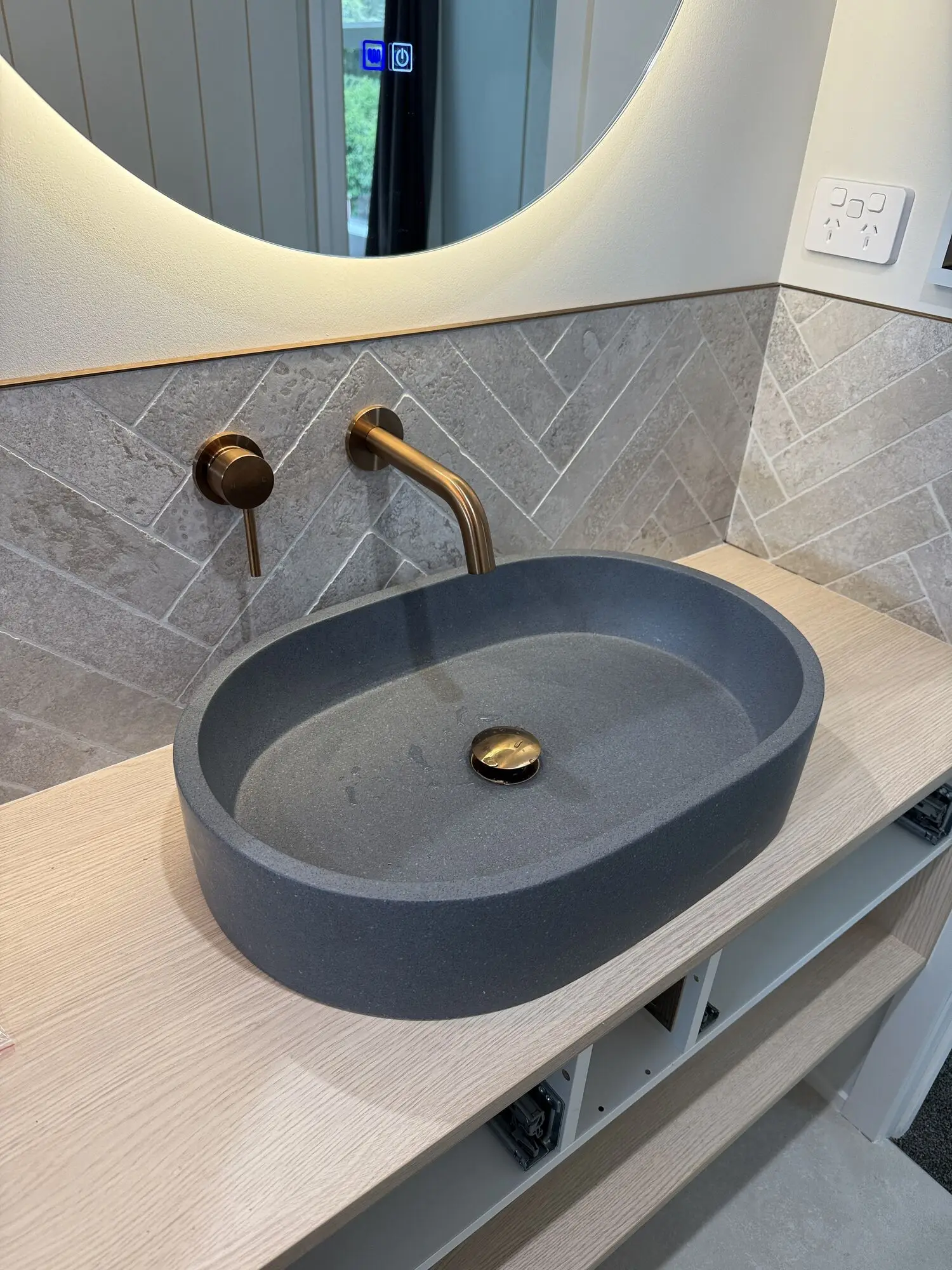 Bathroom vanity with a concrete basin and copper wall mixer that we plumbed