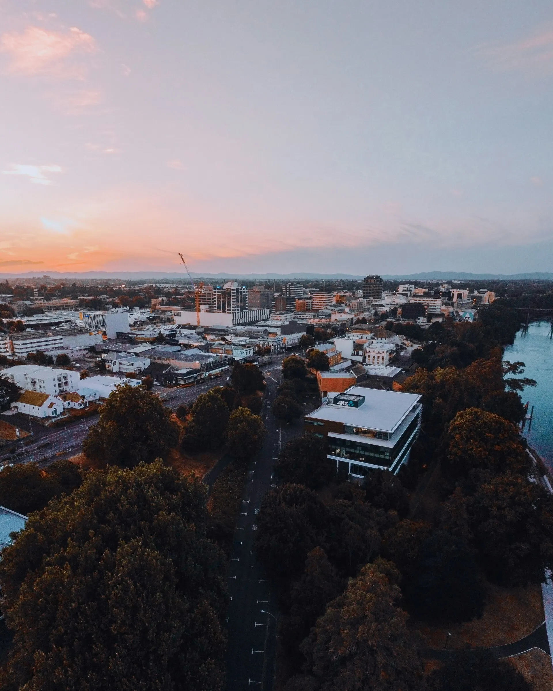 Hamilton city centre and the Waikato River at dusk, from the air